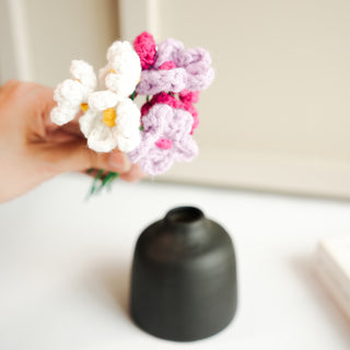 black bud vase with mini crochet daisies