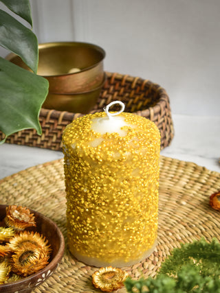 Pillar candle with yellow dry flowers