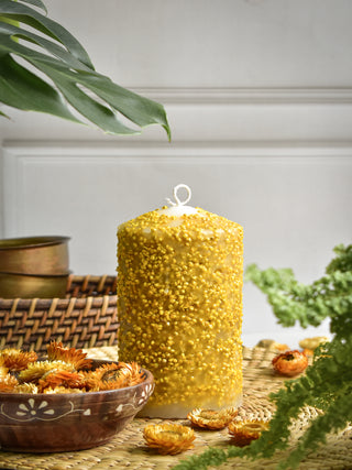 Pillar candle with yellow dry flowers