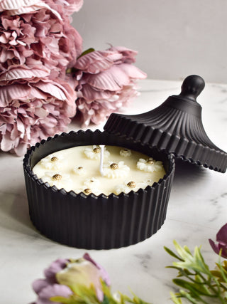 "Soy wax candle with white daisy flower decoration"